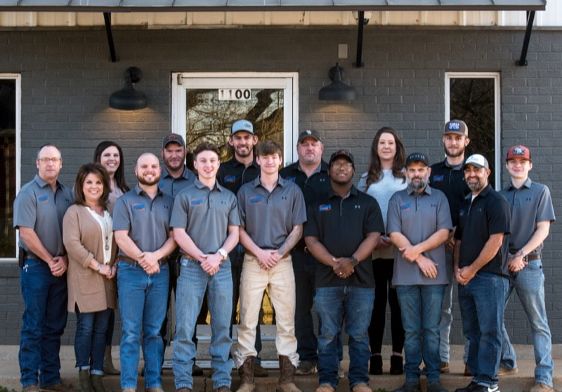 A group company photograph of the team at Moore's A/C & Heating Inc. 