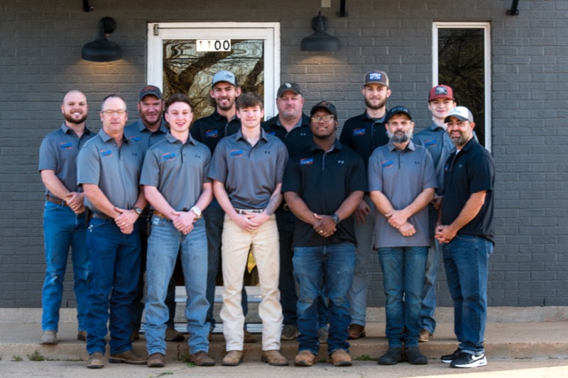 A group company photograph of the team at Moore's A/C & Heating Inc. 